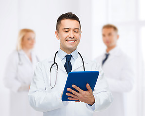 Image showing smiling male doctor with tablet pc at hospital