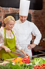 Image showing happy male chef cook with woman cooking in kitchen