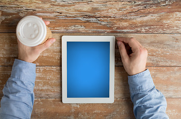 Image showing close up of male hands with tablet pc and coffee