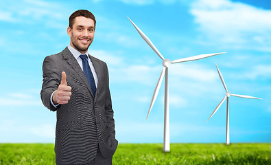 Image showing handsome businessman showing thumbs up