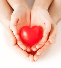 Image showing couple hands holding red heart