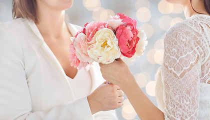 Image showing close up of happy lesbian couple with flowers