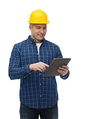 Image showing smiling male builder in helmet with tablet pc