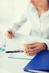 Image showing woman with coffee filling in blank paper
