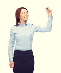 Image showing businesswoman writing something in air with marker