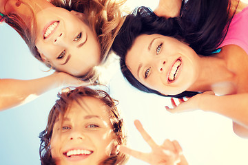 Image showing girls faces with shades looking down