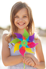 Image showing happy girl with colorful pinwheel toy