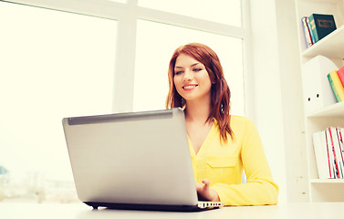 Image showing businesswoman with laptop computer in office