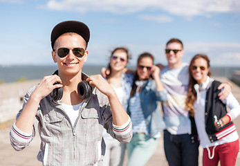 Image showing teenage boy with sunglasses and friends outside