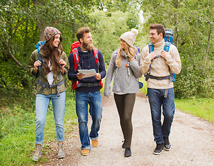 Image showing group of smiling friends with backpacks hiking