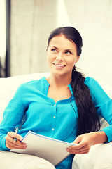 Image showing happy woman with big notepad