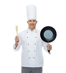 Image showing happy male chef holding frying pan and spatula