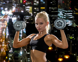 Image showing sporty woman with heavy steel dumbbells