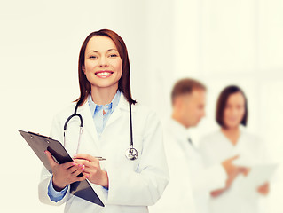 Image showing smiling female doctor with clipboard