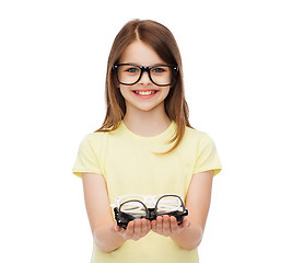 Image showing smiling cute little girl in black eyeglasses