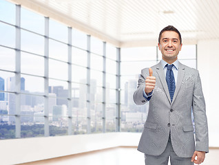 Image showing happy businessman in suit showing thumbs up