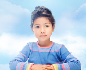 Image showing little girl over blue sky background