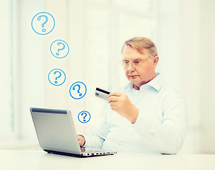 Image showing old man with laptop and credit card at home