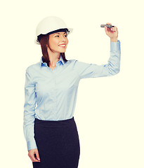 Image showing businesswoman in helmet writing on virtual screen
