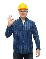 Image showing smiling male builder in helmet showing ok sign