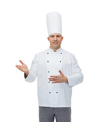 Image showing happy male chef cook inviting