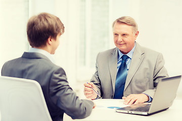 Image showing older man and young man having meeting in office