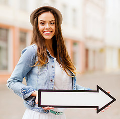 Image showing girl showing direction with arrow in the city