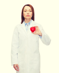 Image showing serious female doctor with heart