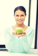 Image showing lovely housewife with green apple