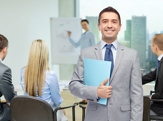 Image showing happy businessman with open folder