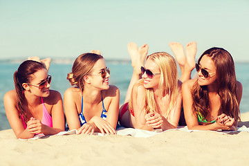 Image showing group of smiling women in sunglasses on beach