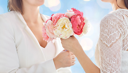 Image showing close up of happy lesbian couple with flowers