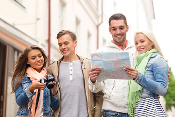 Image showing group of smiling friends with map and photocamera