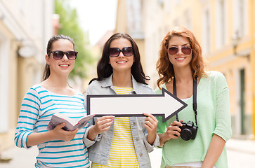 Image showing smiling teenage girls with white arrow outdoors