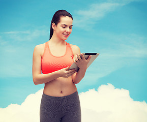 Image showing sporty woman with tablet pc computer