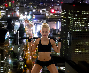 Image showing sporty woman exercising with barbell