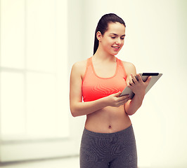 Image showing sporty woman with tablet pc computer