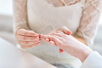 Image showing close up of lesbian couple hands with wedding ring