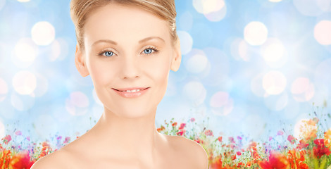 Image showing beautiful young woman face over blue background