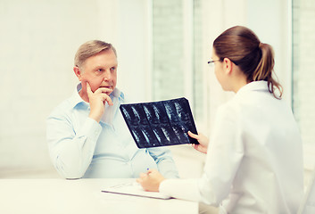 Image showing female doctor with old man looking at x-ray