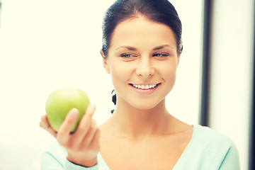 Image showing lovely housewife with green apple