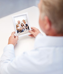 Image showing close up of old man holding happy family photo