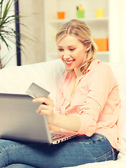 Image showing happy woman with laptop computer and credit card