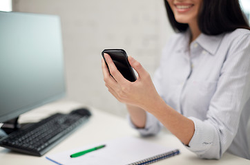 Image showing close up of woman texting on smartphone at office