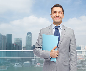 Image showing happy businessman holding folder