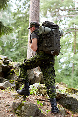 Image showing young soldier with backpack in forest