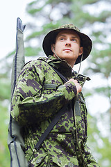 Image showing young soldier or hunter with gun in forest