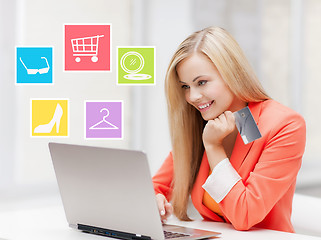 Image showing happy businesswoman with laptop and credit card