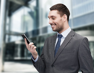 Image showing young smiling businessman with smartphone