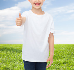 Image showing close up of boy in white t-shirt showing thumbs 
